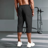 Back view of black men's capri running pants showing fit and length at gym