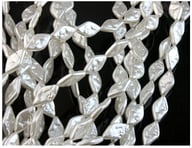 String of white baroque pearl ABS beads close-up view showing hole placement