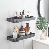 Two gray 304 stainless steel bathroom storage racks with toiletries and accessories