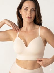 Woman wearing beige wireless shaping bra and matching underwear set showing comfort fit