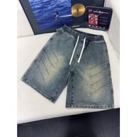 Close-up of men's denim shorts with faded wash effect and seams