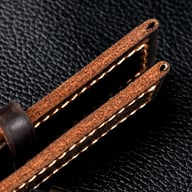 Handmade leather watch strap showing detailed grain and edge construction