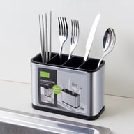 Stainless steel cutlery holder with four compartments filled with kitchen utensils
