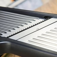 Close-up of professional mandoline slicer's stainless steel blade