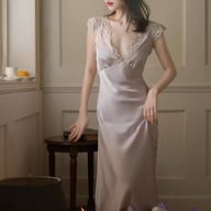 Woman wearing slim-fit ice-silk nightgown with lace trim in bedroom setting
