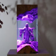 Saint Sebastian resin lamp with purple ambient lighting on display