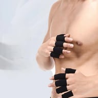 Man wearing black finger compression sleeves on both hands during basketball