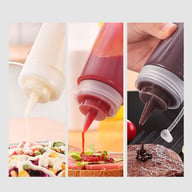 Close-up of sauce dispensing from squeeze bottle onto food