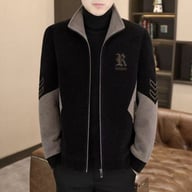Man wearing black and grey stand-neck jacket with KINGROSE logo and chevron sleeve pattern