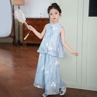 Back view of girl in blue floral two-piece outfit showing mandarin collar vest