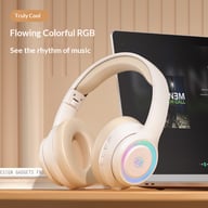 Beige fashionable on-ear Bluetooth wireless headphones with RGB lighting on desk