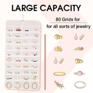 White 80-pocket jewelry organizer displaying earrings, rings, and necklaces clearly