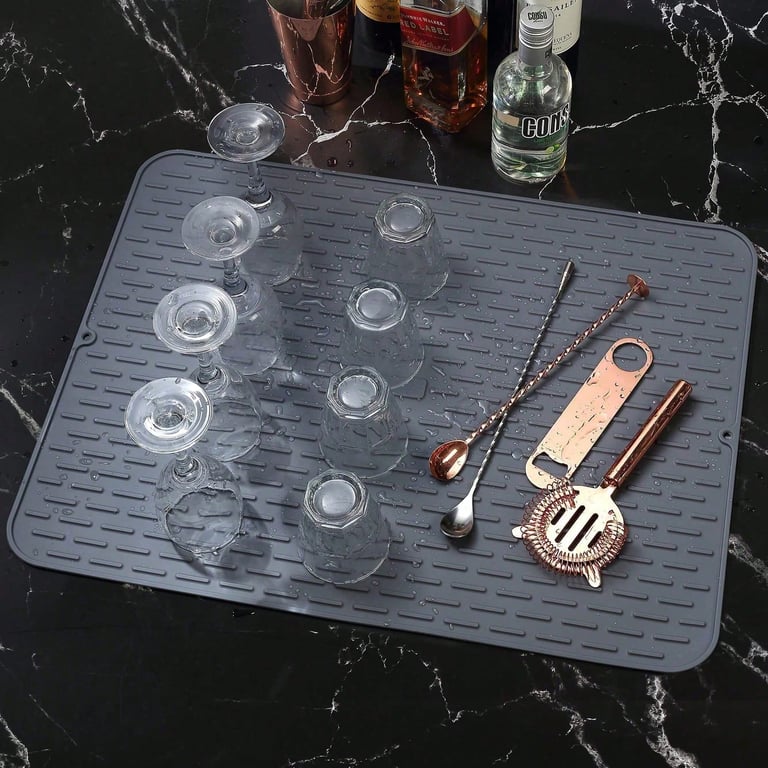 Silicone heat trivet with hot pot and dishes on marble countertop