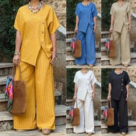 Woman wearing yellow striped two-piece set with asymmetrical button shirt and straw bag