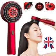 Woman using red light therapy scalp massage comb for hair growth