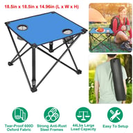 Blue portable camping table in outdoor use with carrying bag