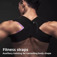 Man wearing black adjustable posture corrector straps for fitness weight training