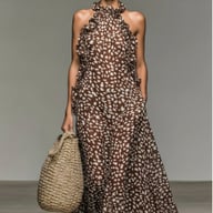 Close-up of brown speckled maxi dress fabric with woven tote bag pairing