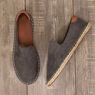 Gray canvas men's slip-on espadrilles on rustic wooden background