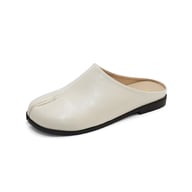 Woman wearing lazy closed-toe pigfoot slippers on hardwood floor