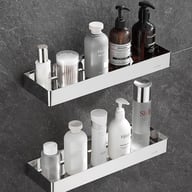 Two silver stainless steel bathroom mirror shelves filled with cosmetics and grooming products