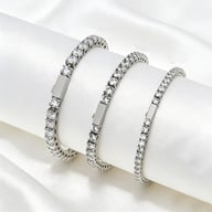 Three stainless steel 316 tennis chains with zircon stones on white fabric background