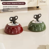 Red and green mechanical kitchen timers on neutral surface
