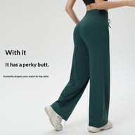 Woman in green high-waisted wide-leg workout pants showing confident fit