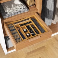 Bamboo drawer organizer with organized cutlery and kitchen utensils inside