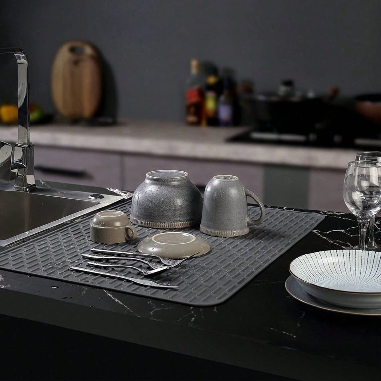 Two gray silicone mats stacked showing flexibility and portability