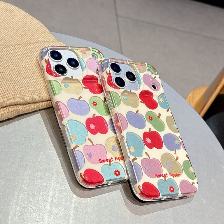 Close-up colorful apple pattern phone case on white surface, detailed artwork visible
