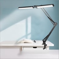 Double-head LED desk lamp with swing arm clamped to desk surface
