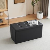Black button-tufted foldable storage ottoman in a living room setting