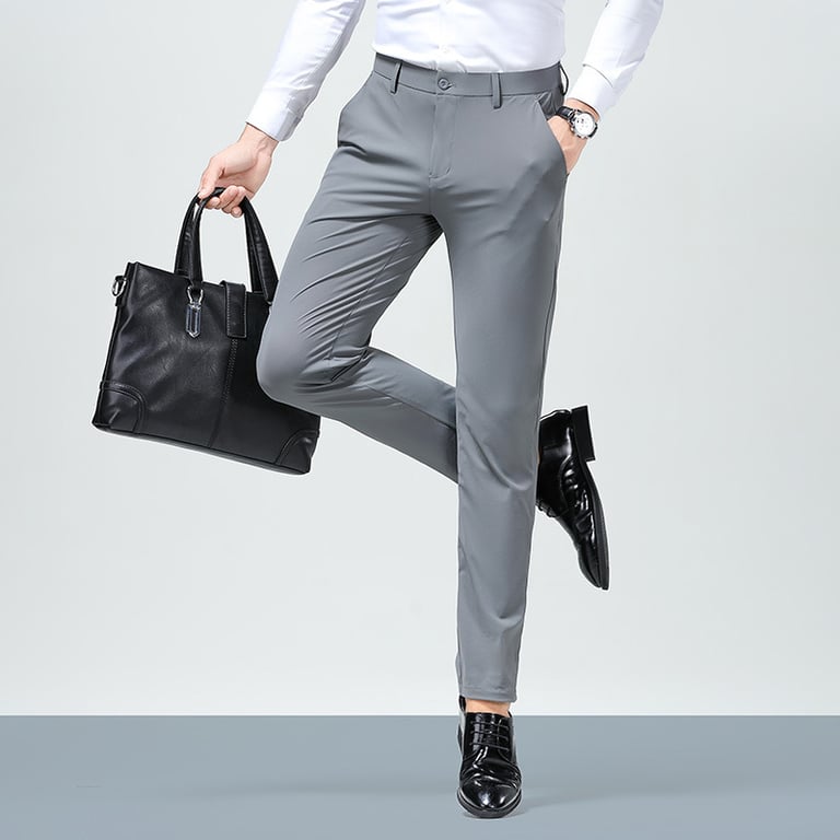 Man walking in black slim fit dress pants, confident stride, urban background