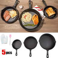 Three cast iron skillets with cooked food, silicone mitt and basting brush accessories