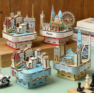Assorted 3D wooden city skyline music boxes displayed showing London, Paris, Dubai, New York models