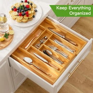 Extendable bamboo drawer organizer fully expanded showing five compartment zones