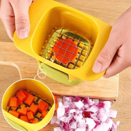 Top-down view of fruit slicer dicing tomato with diced carrots visible nearby