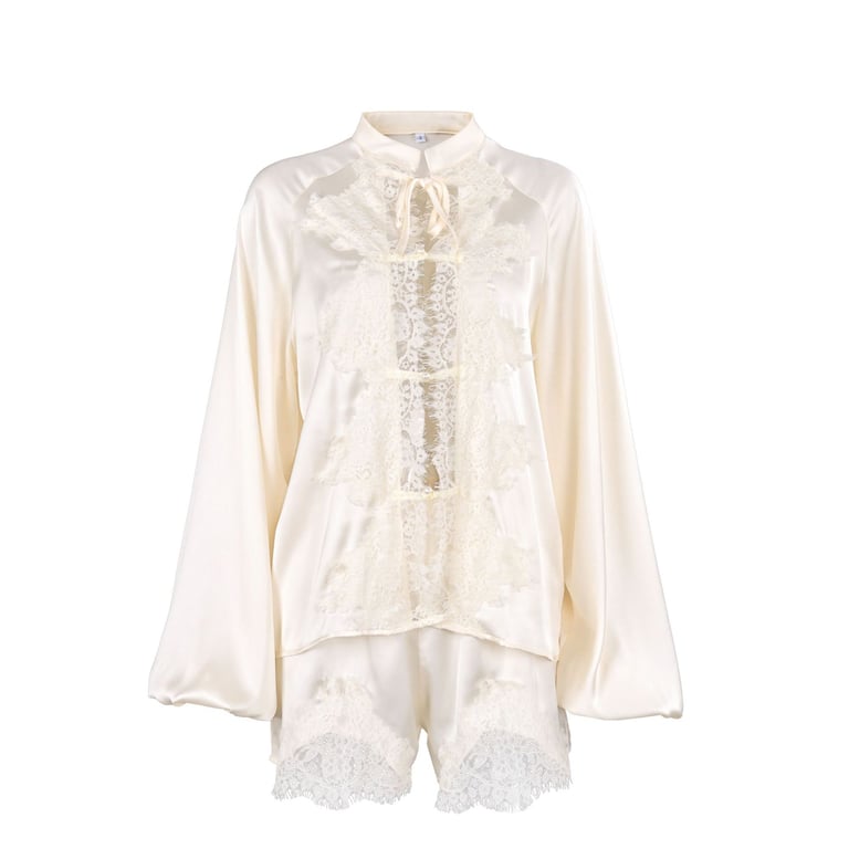 Close-up of ice-silk satin fabric texture and lace trim detail