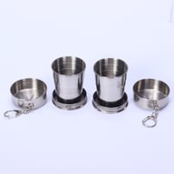 Two collapsed stainless steel telescoping cups in leather pouches