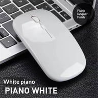 White wireless mute mouse with piano lacquer finish on laptop keyboard