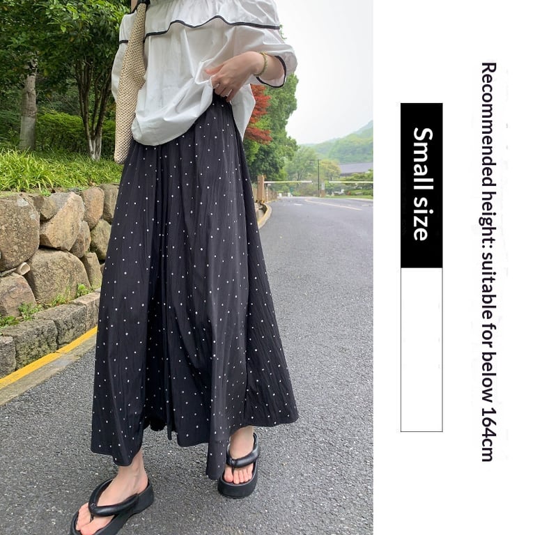 Woman wearing draping wide-leg pants in humid outdoor setting, comfortable and cool