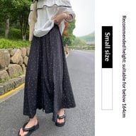 Woman wearing breathable wide-leg pants styled with white sneakers and casual top