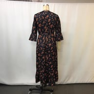 Back view of floral patchwork maxi dress on mannequin showing construction