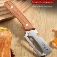 Stainless steel peeler creating uniform vegetable ribbons for salad preparation