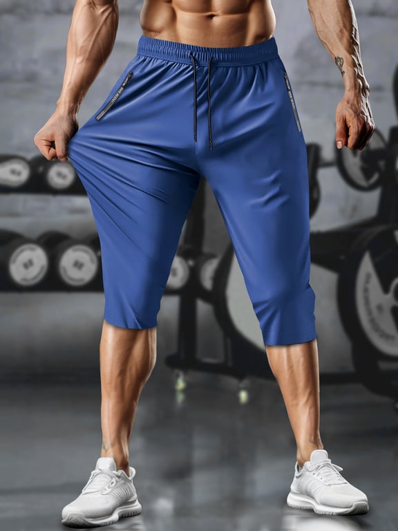 Back view of grey men's capri running pants showing stretch and fit