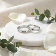 Close-up of 925 silver wavy diamond rings displayed on marble surface