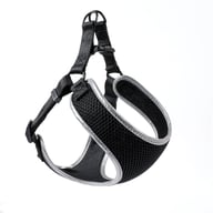 Close-up of reflective vest-style dog harness showing adjustable straps and hardware