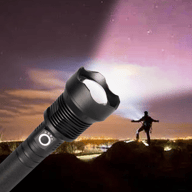 Super bright LED torch illuminating dark landscape with person silhouette