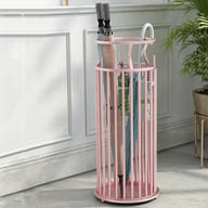 Pink wrought iron umbrella stand with umbrellas in contemporary home setting